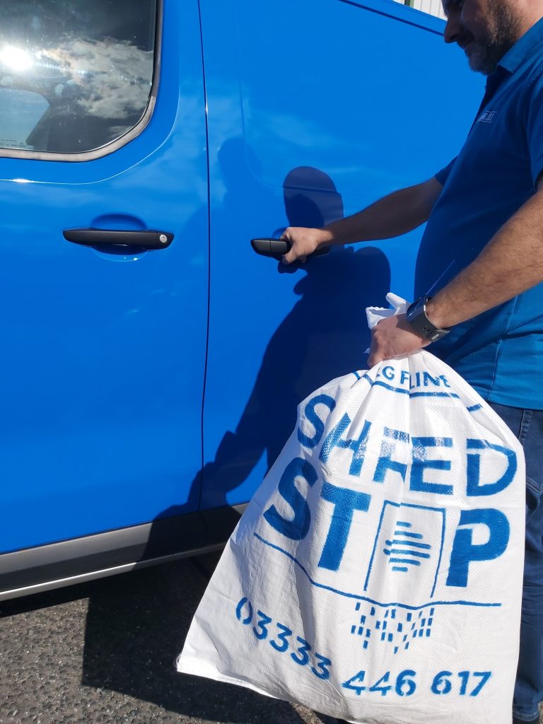 Man Holding a sack foer Shredding